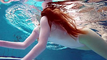 Sandy-haired Simonna demonstrating her figure underwater