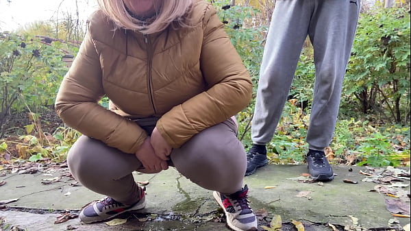 Depraved curvy MILF in stretch pants squats down and pisses next to me