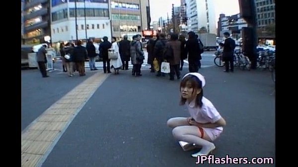 Insane Asian female is pissing in public