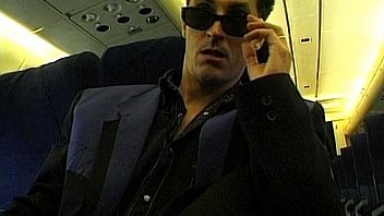 Dark haired beauty dressed in stewardess uniform gets fucked on a plane