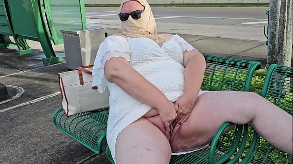 Mature hijab Cougar masturbating with big faux-cock publicly outdoor at bus stop with vans passing by